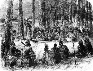 Jesuit missionary teaching the natives. Source - https://colonizationofamerica.wikispaces.com/French+Colonies
